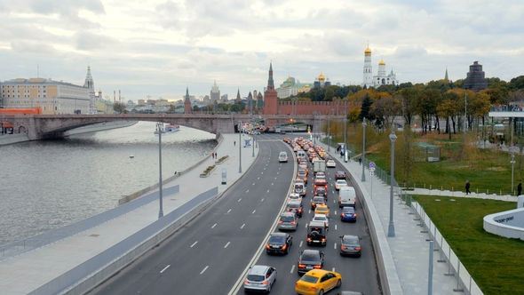 Car Traffic in a Centre of Moscow in Cloudy Morning Near Bridge and City Park