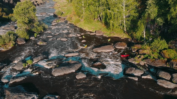 Overhead Aerial Shot of Rafting Boat on Raging Mountain River with Rapids