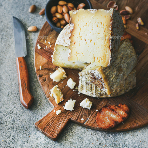 Cheese platter with nuts, honey and bread, square crop - Stock Photo - Images
