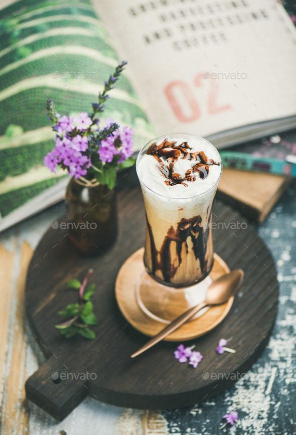 Iced mocha coffee with whipped cream in glass on board - Stock Photo - Images