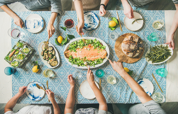 Family or friends having seafood summer dinner - Stock Photo - Images