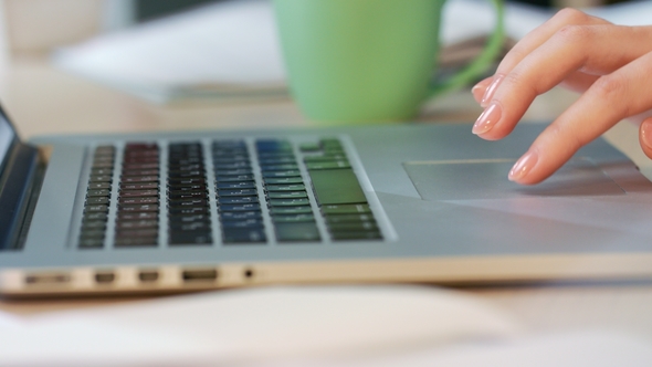 Woman Hands Using Touchpad on Laptop Computer alt