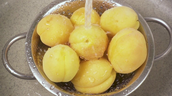 Apricots in a Metal Colander Under the Water