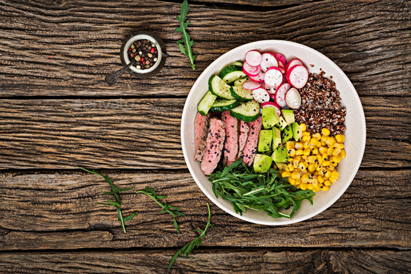 Buddha bowl lunch with grilled beef steak and quinoa, corn, avocado, cucumber - Stock Photo - Images