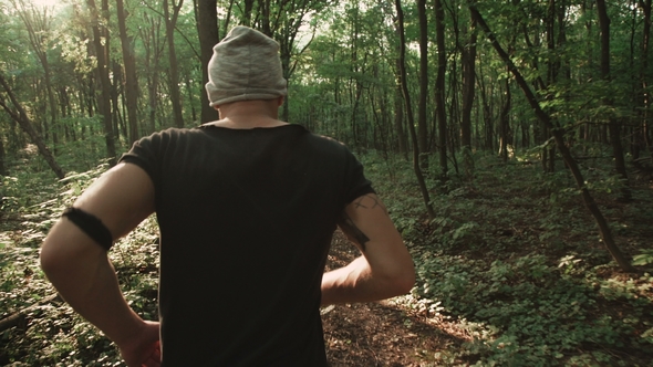 Back View of Male Runner in the Forest alt
