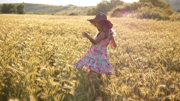 Girl with a Hat in a Wheat Field