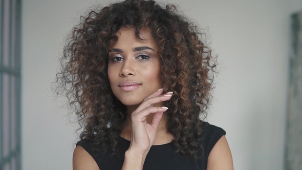 Portrait of a Beautiful Hispanic Girl. a Girl with Brown Eyes. Evening Make-up and Hairstyle