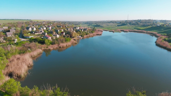 Aerial View of Country Houses on the Hill on Shore of the Pond in the Morning alt