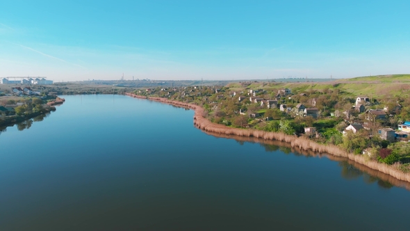 Aerial View of Country Houses on the Hill on Shore of the Pond in the Morning