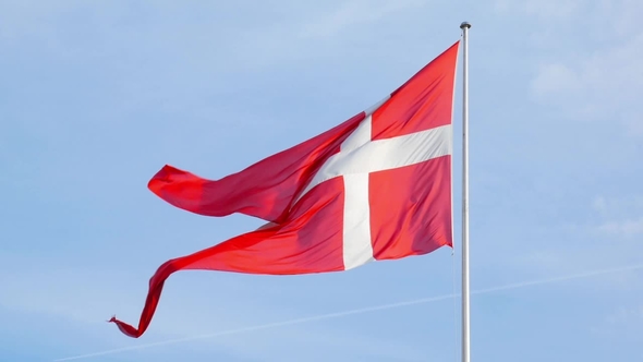 Waving Flag of Denmark in Background of Blue Sky
