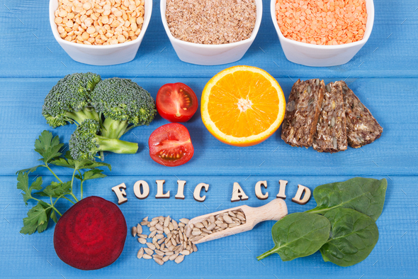 Inscription folic acid with nutritious different ingredients containing vitamin B9 and minerals Stock Photo by ratmaner