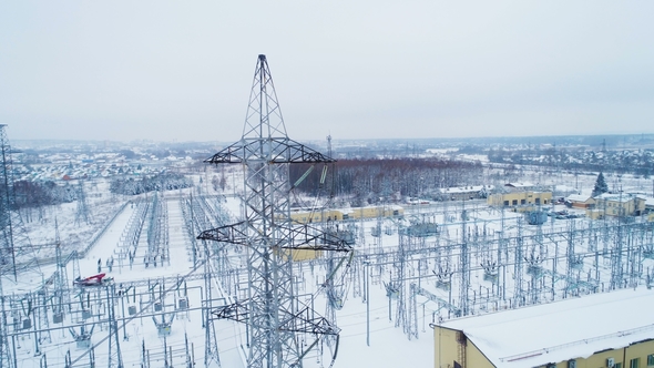 Tower Holds Wires Conducting Alternating Current Above Substation alt