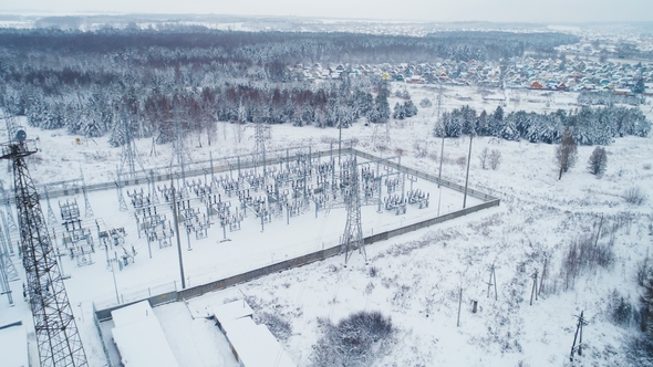Industrial Buildings and Insulators on Station Territory Covered with Snow alt