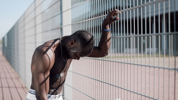  African American Athlete Restores His Strength After a Heavy Workout Outdoors alt