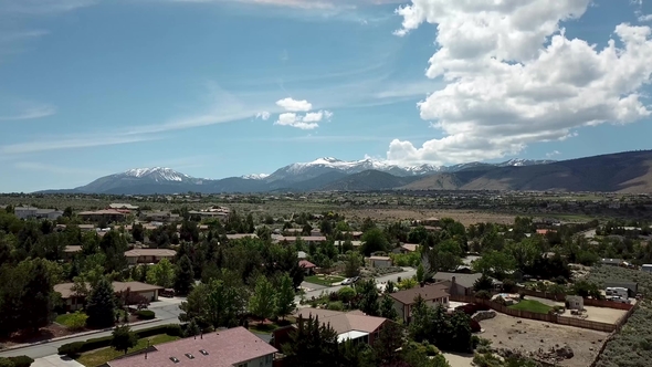 White Clouds Over American Town on the Background of the Mountains alt