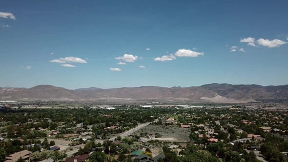 Aerial, White Clouds Over American Town on the Background of the Mountains alt