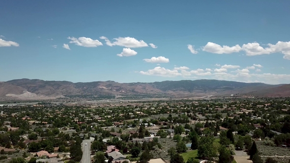 White Clouds Over American Town on the Background of the Mountains