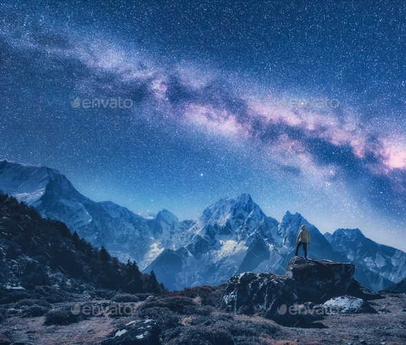 Silhouette of a standing man and Milky Way at night in Nepal Stock Photo by den-belitsky