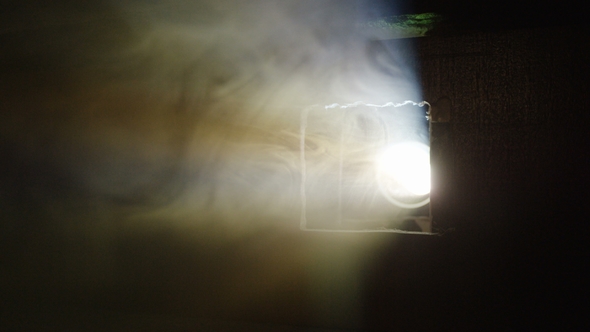 Smoke Cloud Hides Cinema Projector in Darkness alt