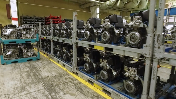 Prepared Car Engines Are Standing in Shelfs in Workshop of Modern Automobile Factory