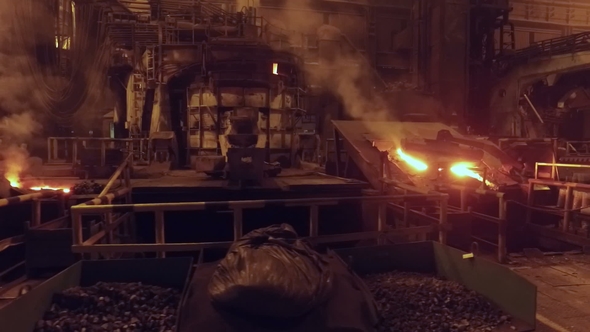 Moving Shot in Foundry in Metallurgical Plant, Open Fire and Red-hot Metal in Blast Furnace