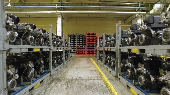 Prepared Car Engines Are Standing in Warehouses Racks of Modern Automobile Factory, Moving Shot