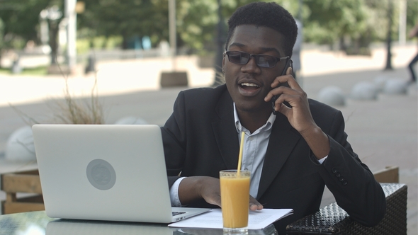 Young Attractive Afro American Businessman with Glasses and Laptop alt