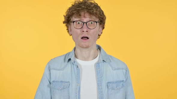 Redhead Young Man Feeling Shocked Yellow Background alt