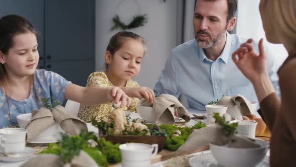 Caucasian family of five spending time over table on easter time. Shot with RED helium camera in 8K. alt
