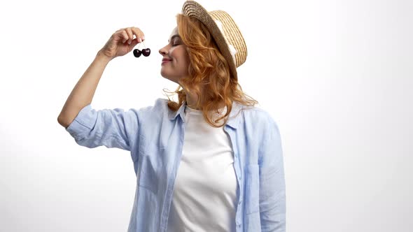 Smiling Lady in Straw Summer Hat Smell and Eat Fresh Ripe Sweet Cherry Berry Diet