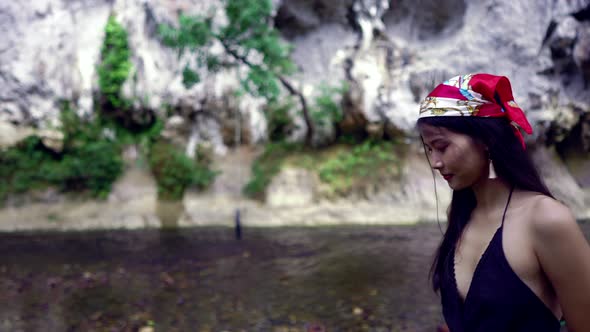 Cute Asian Girl Walking Next to the River Thailand alt