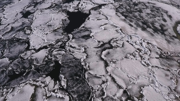 Aerial View Over the Surface of River and Cracked Ice