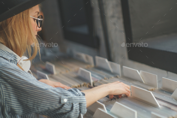 Young girl browsing records in the store Stock Photo by AboutImages