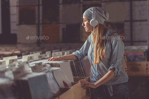 Young girl with headphones in a store Stock Photo by AboutImages | PhotoDune