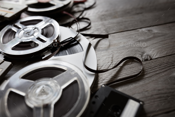 Old audio reels and cassette tape background Stock Photo by BrianAJackson