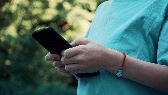 Young Guy Uses an Application on Your Smartphone or Climbs in Social Networks.