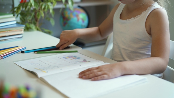 Side View of a Little Girl Doing Her Homework
