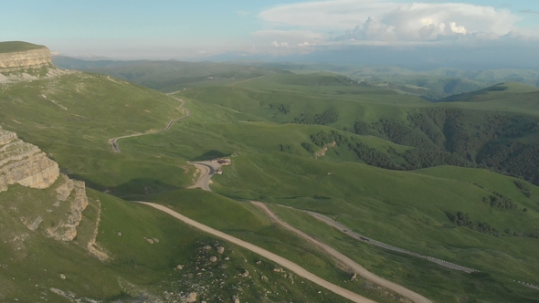 AERIAL: Flight Over a High Rock Cliff, Revealing a View of the Pass in Russia in the Northern alt