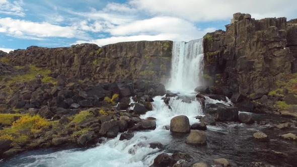 Small Amazing Waterfall Oxararfoss and River in Iceland, Basalt Rocks and Yellowed Grass in Autumn