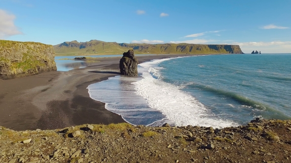 Panorama From Ground To Landscape with Ocean Waves and Rocks on a Southern Coastline of Iceland
