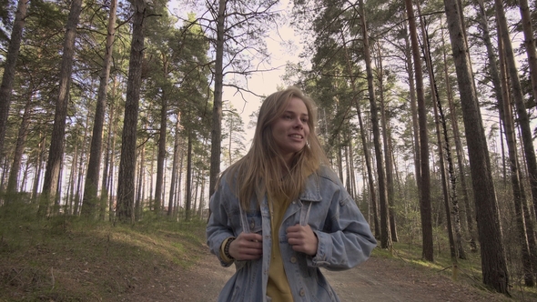 Young Smiling Girl Walking in the Autumn Forest alt
