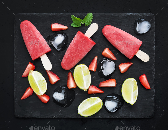 Strawberry and lime ice-creams or popsicles with fresh cut berries - Stock Photo - Images