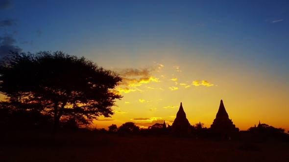 Silhouette of Temples and Tree in Bagan at Sunset alt