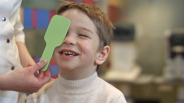 Handsome Boy Under Ophthalmologist Examination alt