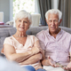 Happy senior couple taking financial advice at home - $5.00 Happy senior couple taking financial advice at home
