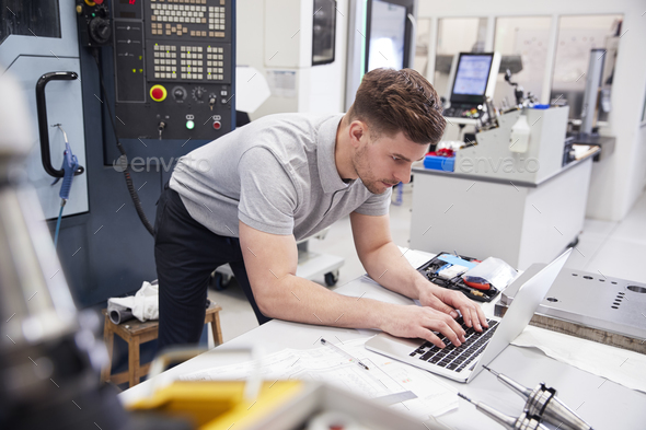 Male Engineer Using CAD Programming Software On Laptop Stock Photo by monkeybusiness
