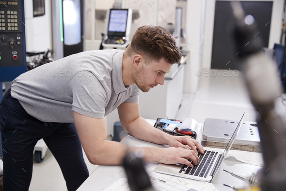 Male Engineer Using CAD Programming Software On Laptop Stock Photo by monkeybusiness
