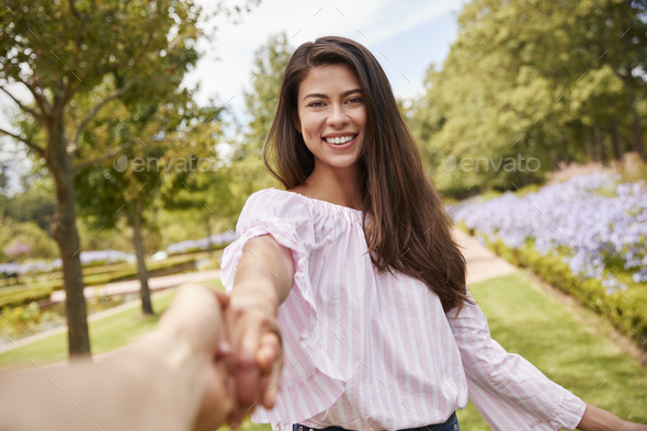 Point Of View Shot Of Romantic Couple Walking In Park Together Stock Photo by monkeybusiness