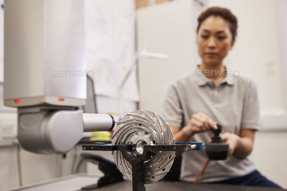 Female Engineer Uses CMM Coordinate Measuring Machine In Factory Stock Photo by monkeybusiness