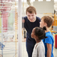 Teacher and kids talking about a science exhibit - $5.00 Teacher and kids talking about a science exhibit
